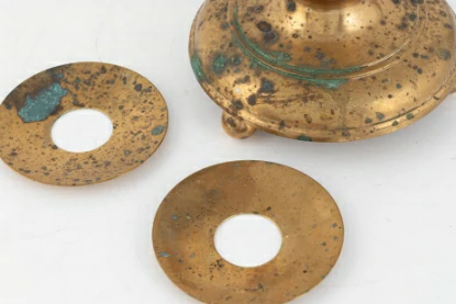 brass with small localized pits or holes due to an aggressive environment